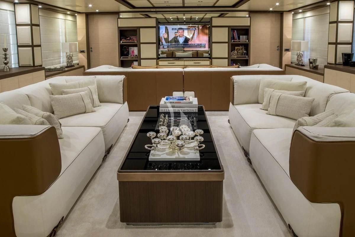 a living room with a large screen aboard NELA Yacht for Charter