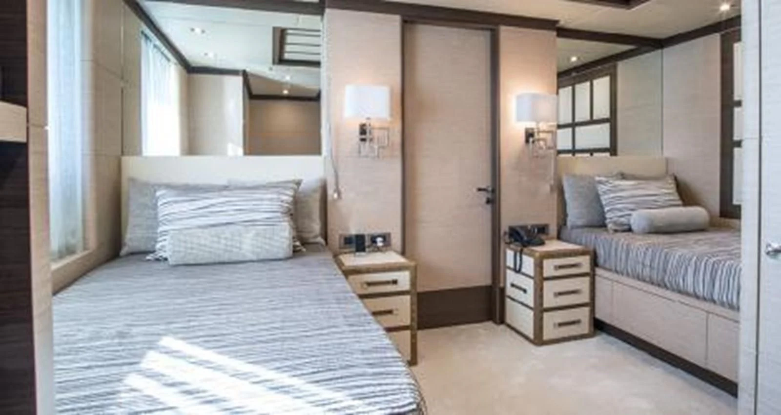 a room with a bed and a dresser aboard NELA Yacht for Charter
