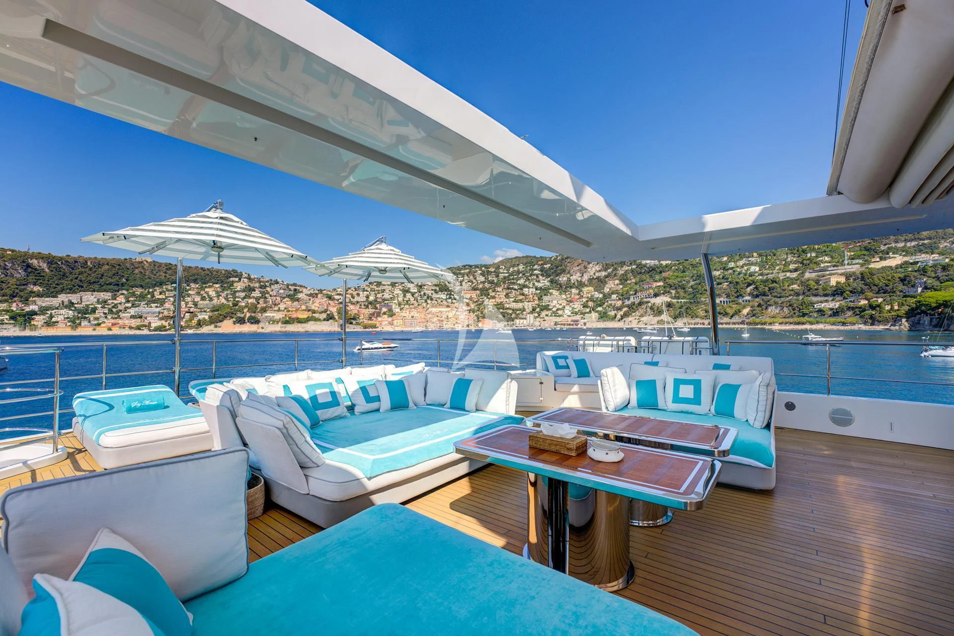 a pool with a table and chairs aboard NELA Yacht for Charter