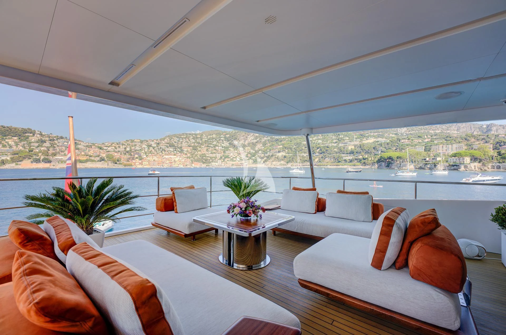 a room with couches and a table with plants in it aboard NELA Yacht for Charter