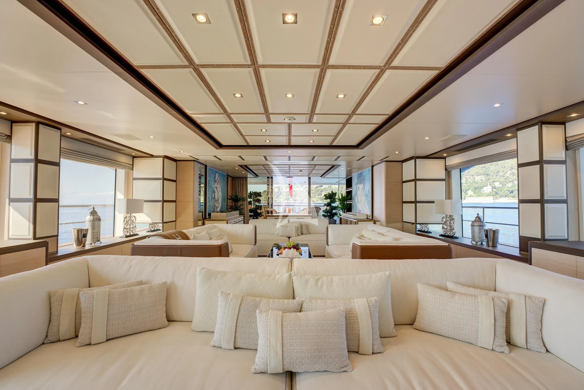 a large living room with a large window aboard NELA Yacht for Charter