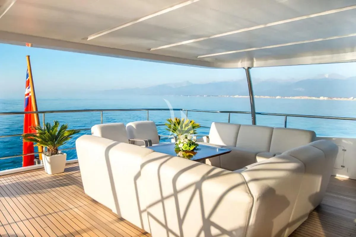 a room with a couch and a table and a flag aboard NELA Yacht for Charter