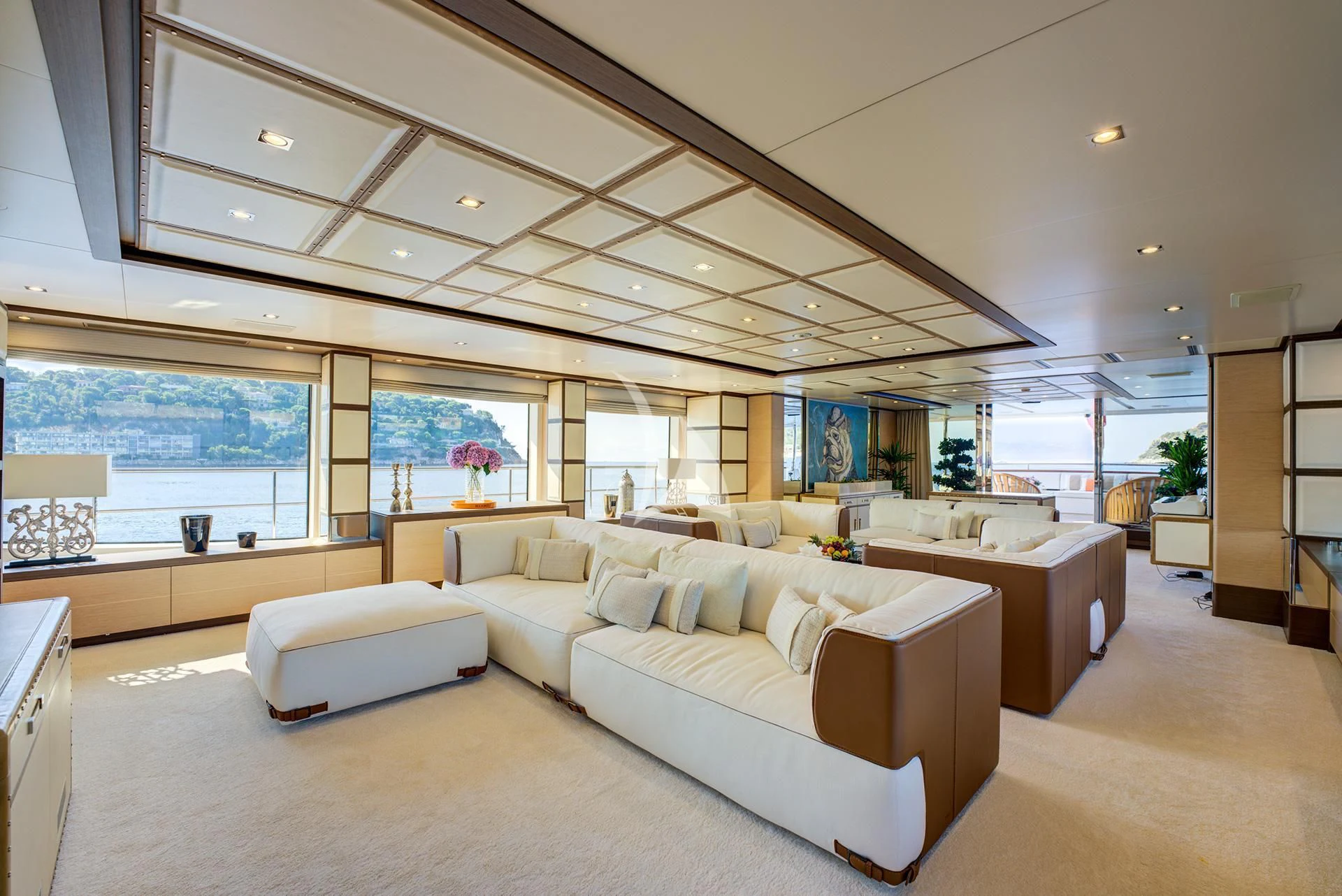 a large living room with a large open window aboard NELA Yacht for Charter