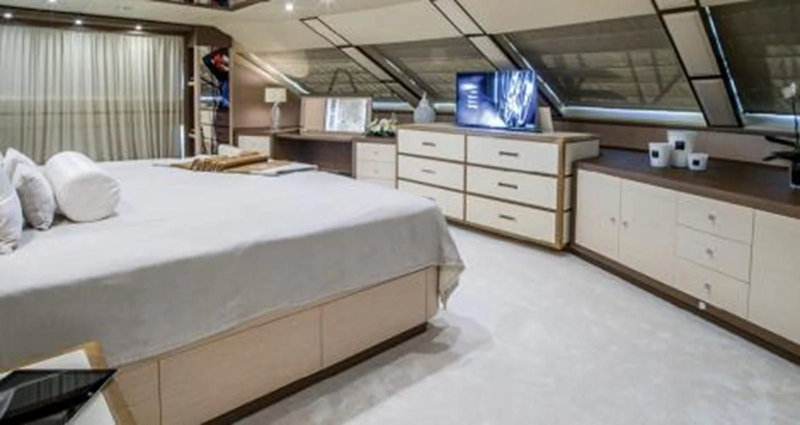 a room with a bed and a desk aboard NELA Yacht for Charter