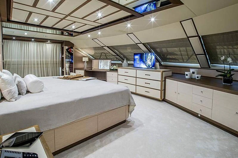 a room with a bed and a desk aboard NELA Yacht for Charter