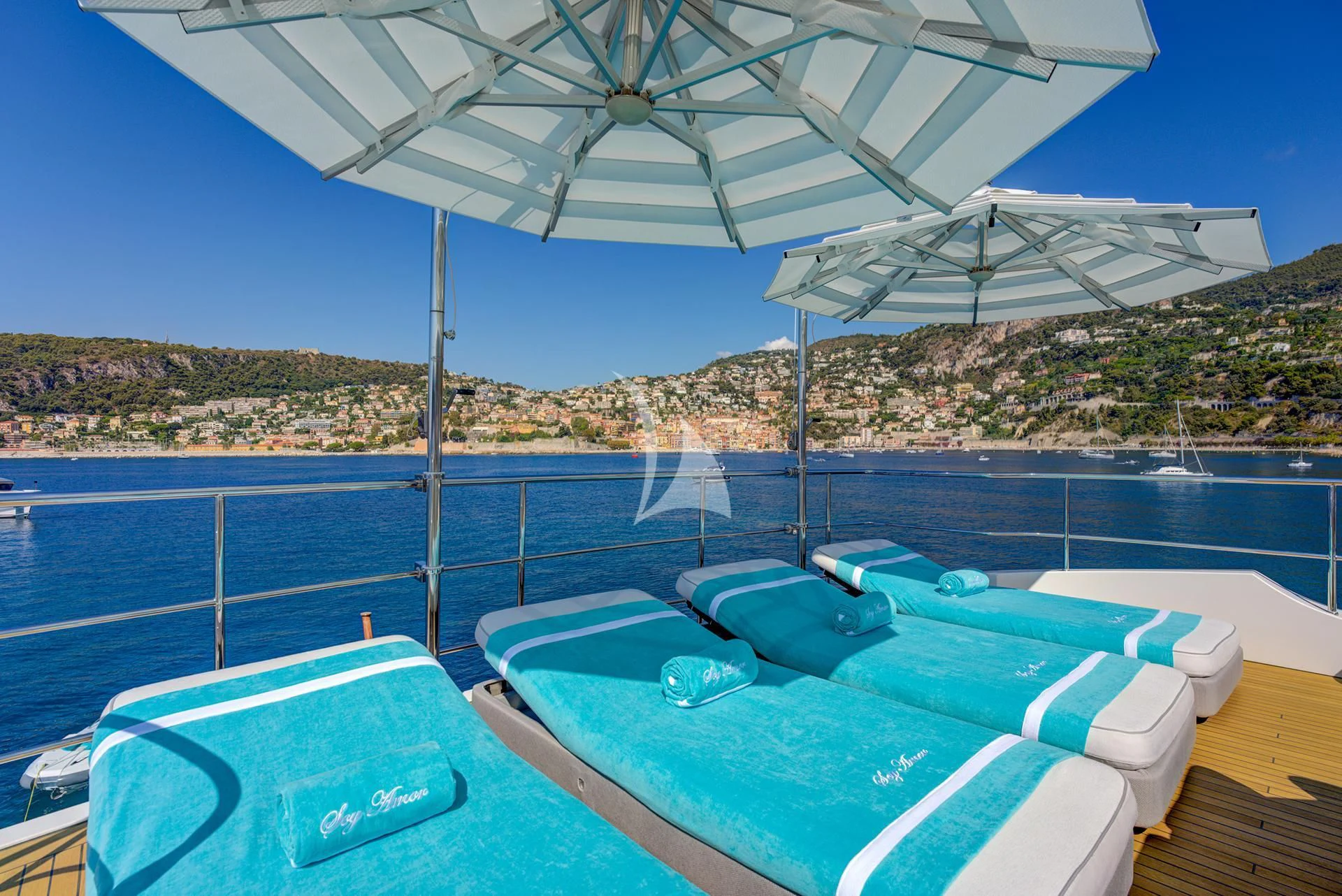 a pool with a large umbrella aboard NELA Yacht for Charter