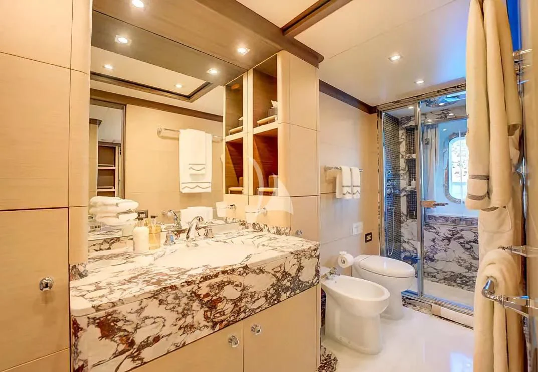 a bathroom with a large marble countertop aboard NELA Yacht for Charter