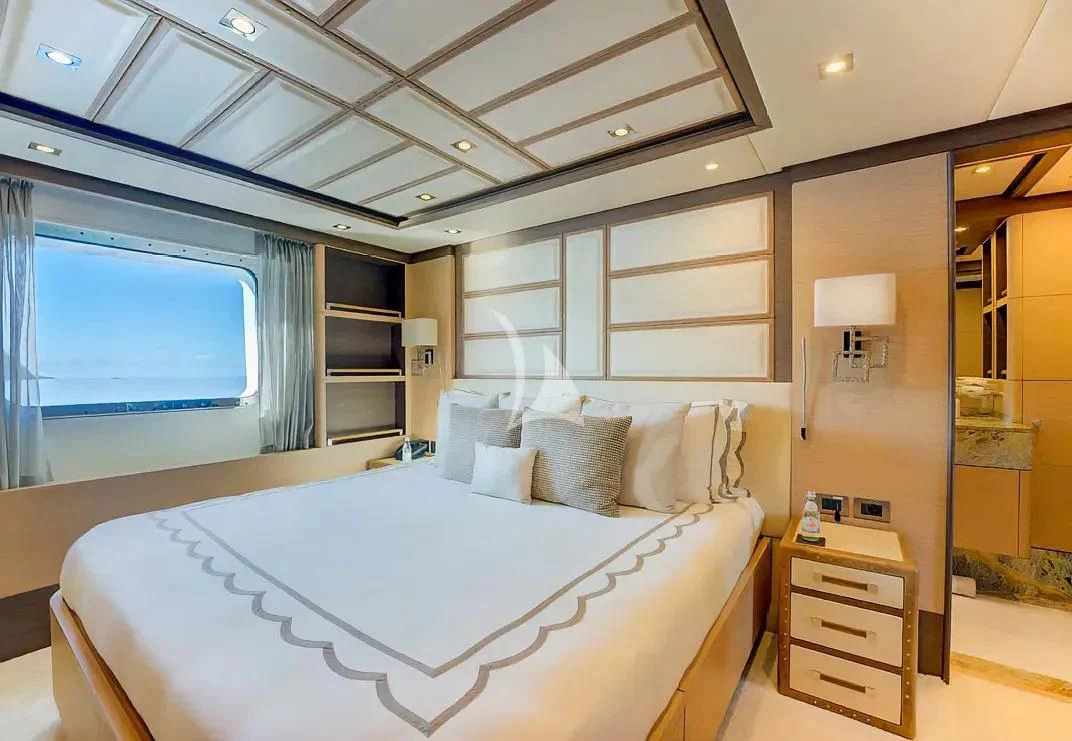 a bedroom with a large bed aboard NELA Yacht for Charter