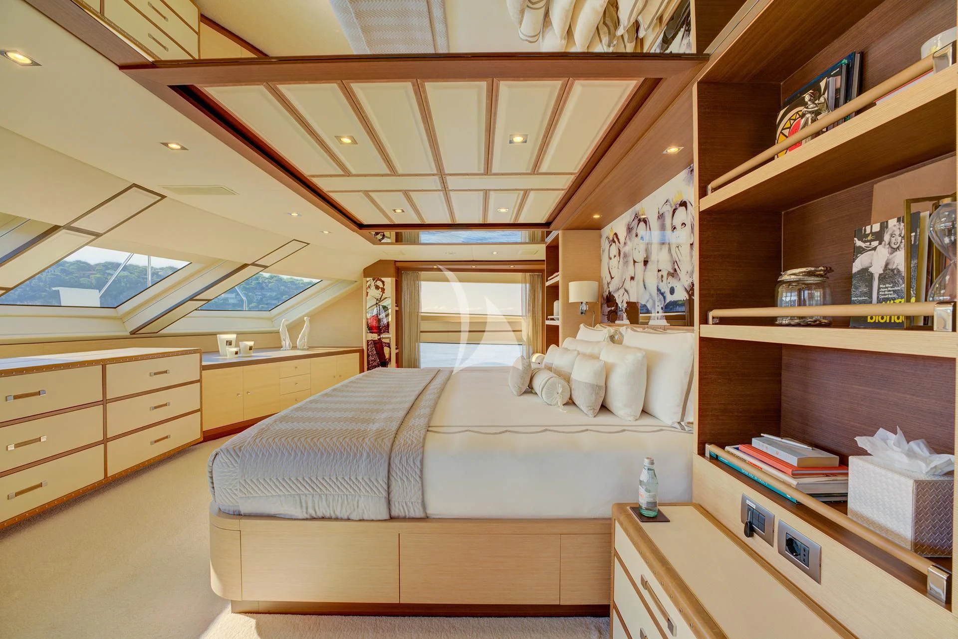 a bedroom with a bed and a book shelf aboard NELA Yacht for Charter