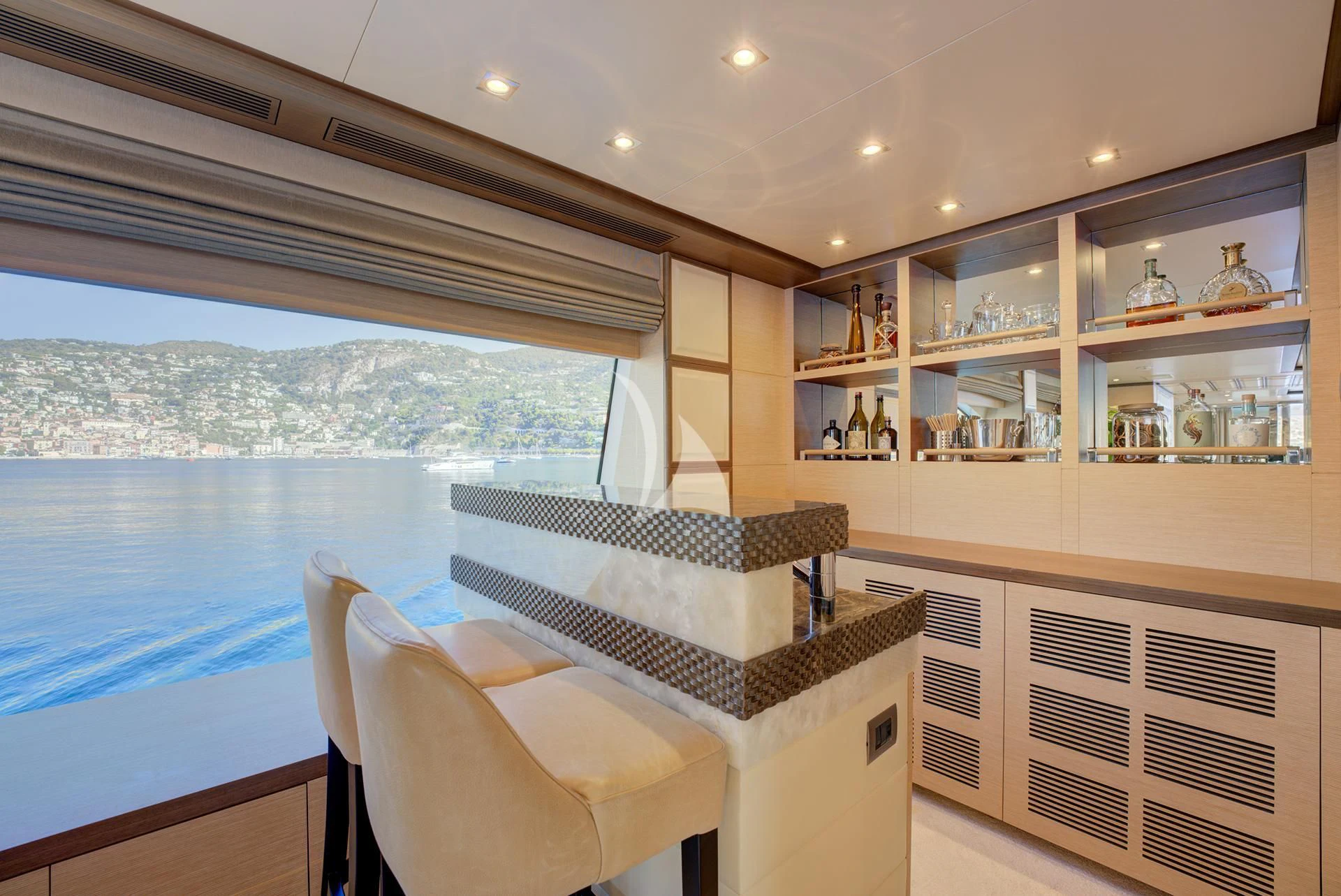 a room with a table chairs and a large window aboard NELA Yacht for Charter