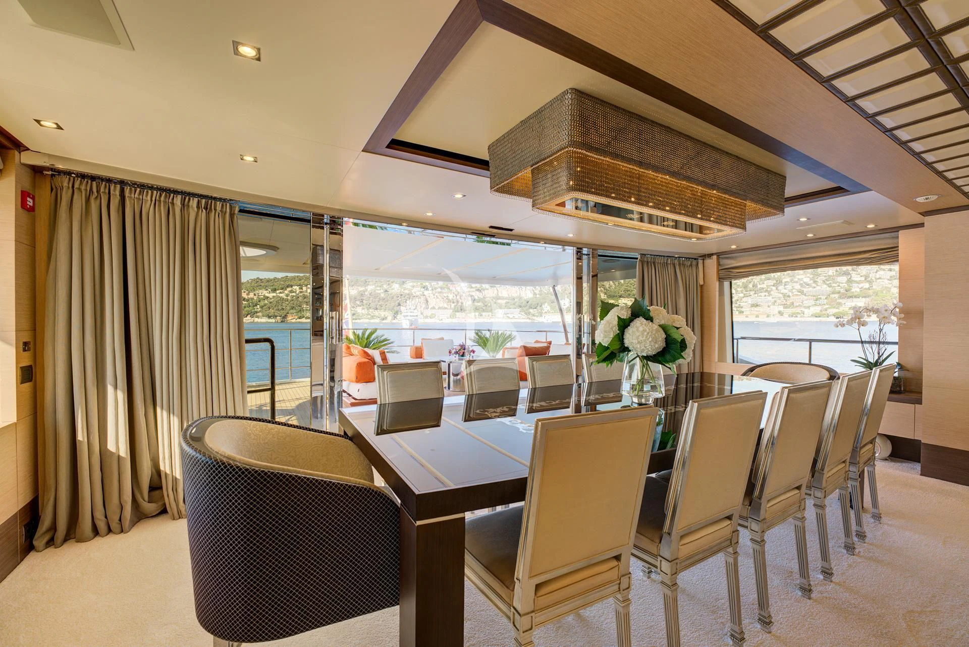 a dining room with a large balcony aboard NELA Yacht for Charter