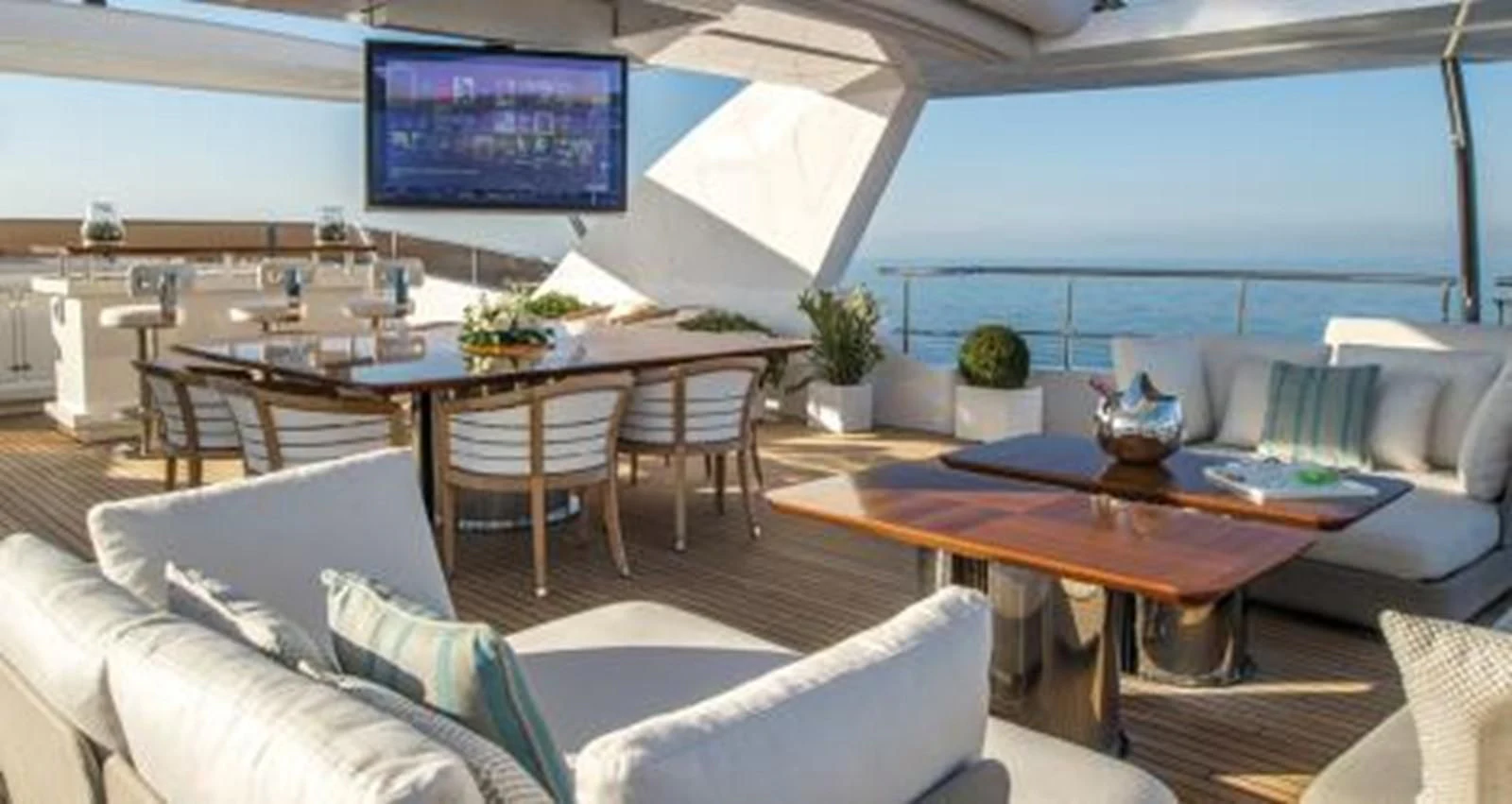 a living room with a large screen aboard NELA Yacht for Charter