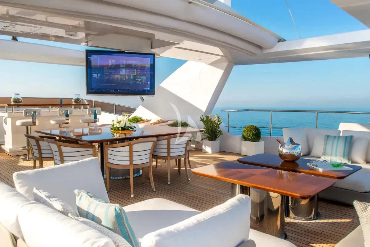 a room with a table and chairs aboard NELA Yacht for Charter