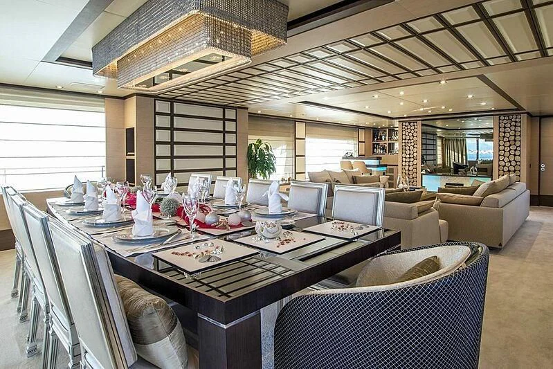 a large room with a table and chairs aboard NELA Yacht for Charter