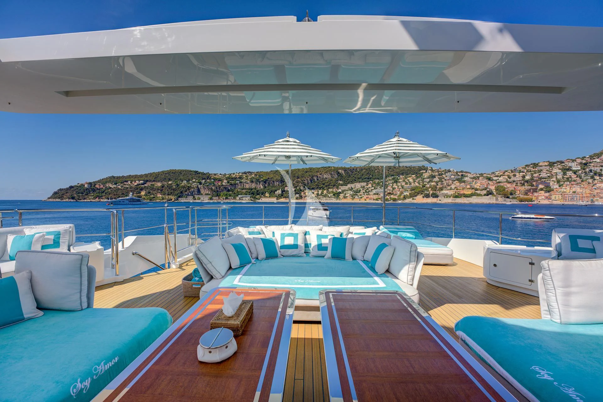 a pool with lounge chairs and umbrellas aboard NELA Yacht for Charter