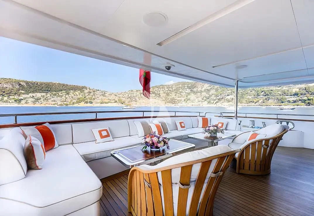 a room with a table and chairs aboard NELA Yacht for Charter