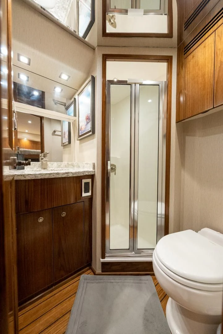 a bathroom with a glass shower door aboard IT JUST TAKES TIME Yacht for Sale