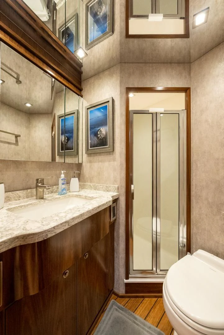 a bathroom with a glass shower door aboard IT JUST TAKES TIME Yacht for Sale