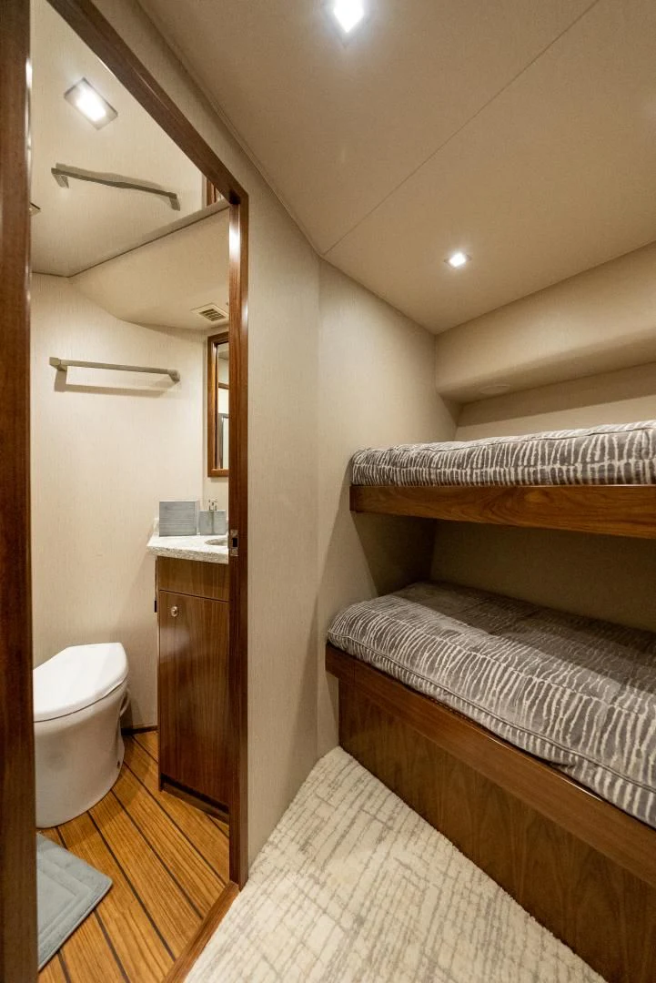 a small bedroom with a bed aboard IT JUST TAKES TIME Yacht for Sale