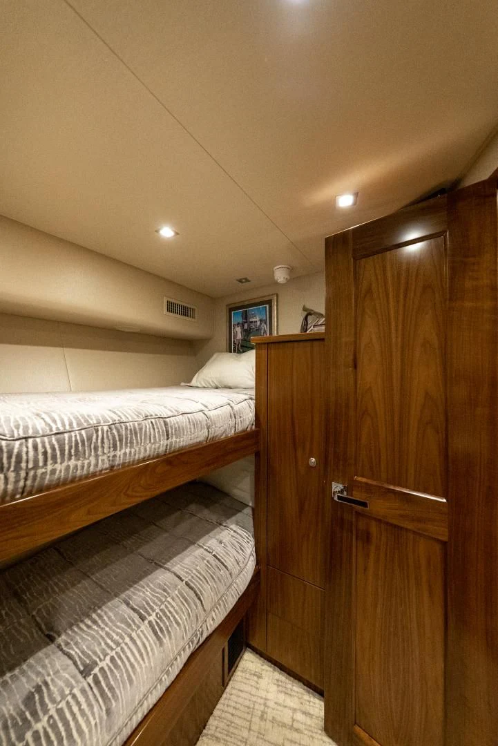 a room with a bed and a closet aboard IT JUST TAKES TIME Yacht for Sale