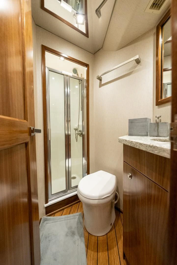 a bathroom with a toilet and a sink aboard IT JUST TAKES TIME Yacht for Sale