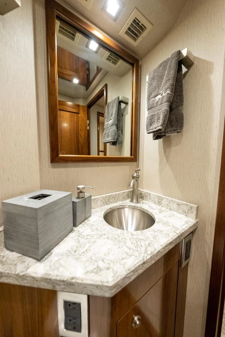 a bathroom with a sink and a mirror aboard IT JUST TAKES TIME Yacht for Sale