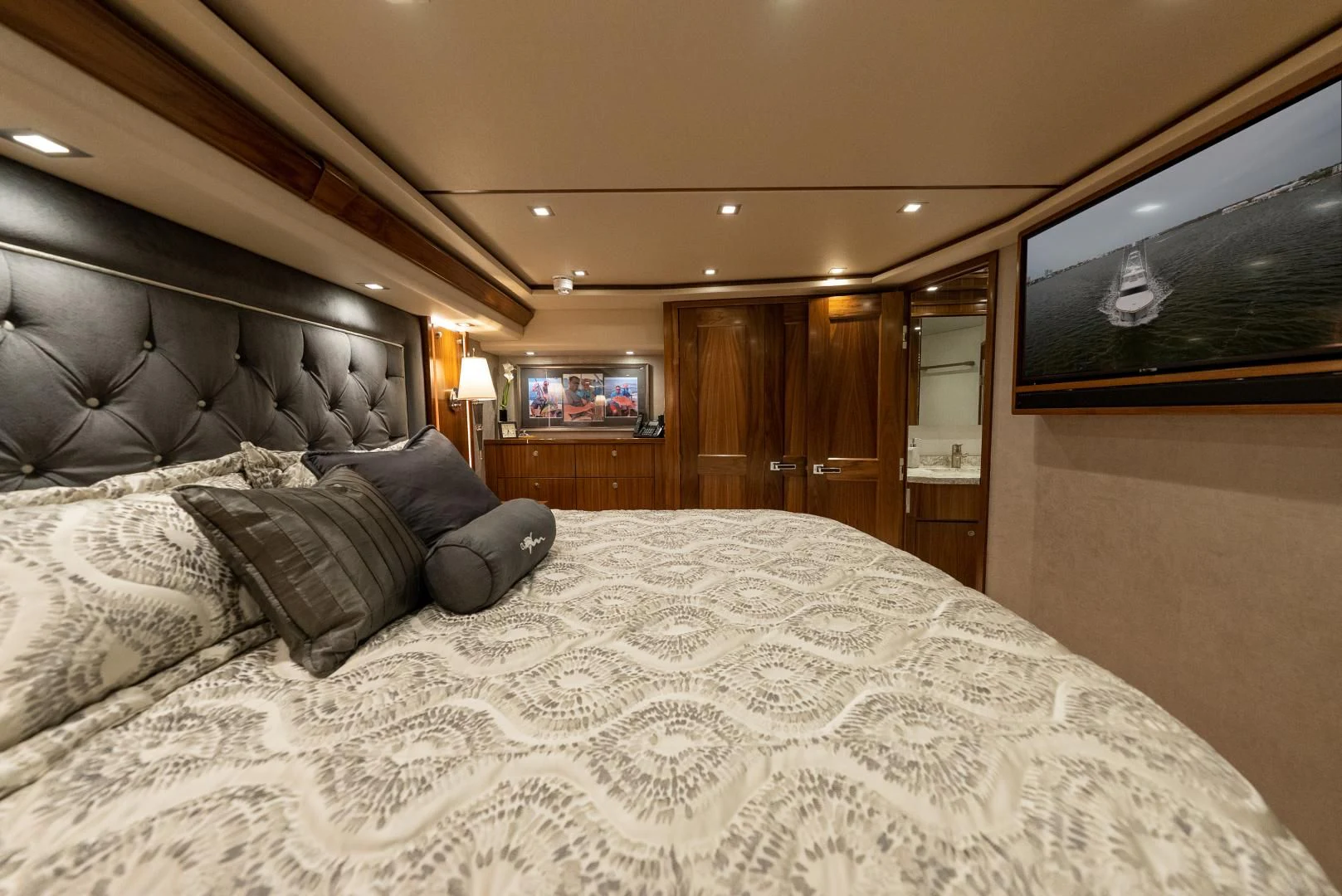 a bed with a television on the wall aboard IT JUST TAKES TIME Yacht for Sale