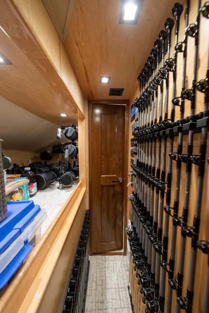 a room with a rack of clothes from the ceiling aboard IT JUST TAKES TIME Yacht for Sale