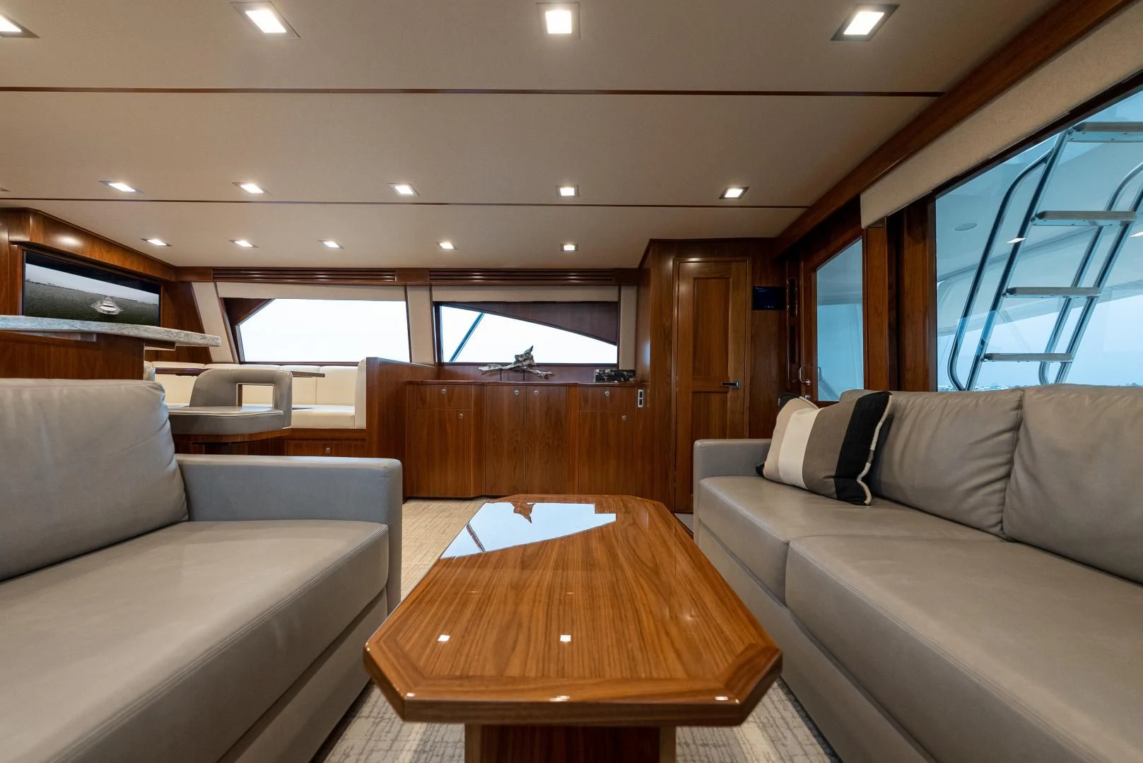 a room with couches and a table aboard IT JUST TAKES TIME Yacht for Sale