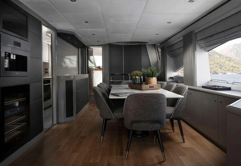 a kitchen with a table and chairs aboard SPACE ODDITY Yacht for Sale