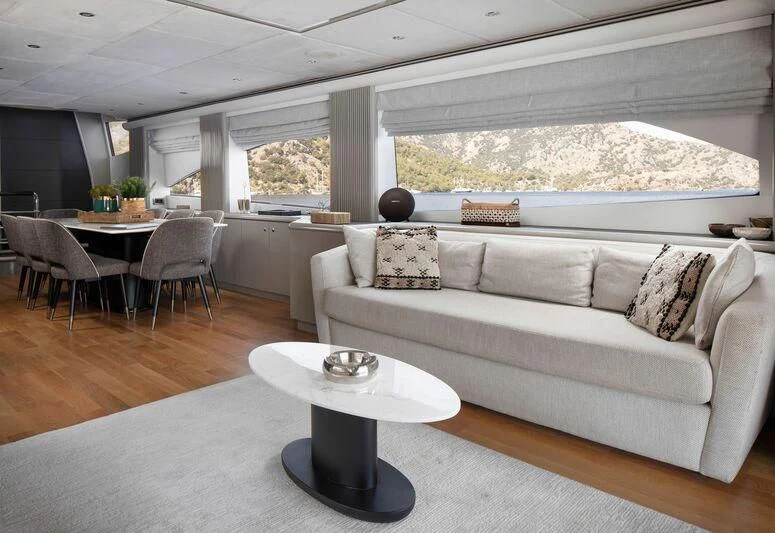 a living room with a couch and a table aboard SPACE ODDITY Yacht for Sale
