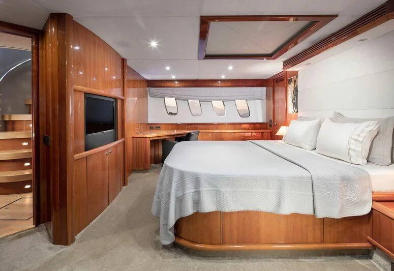 a room with a bed and a television aboard SPACE ODDITY Yacht for Sale