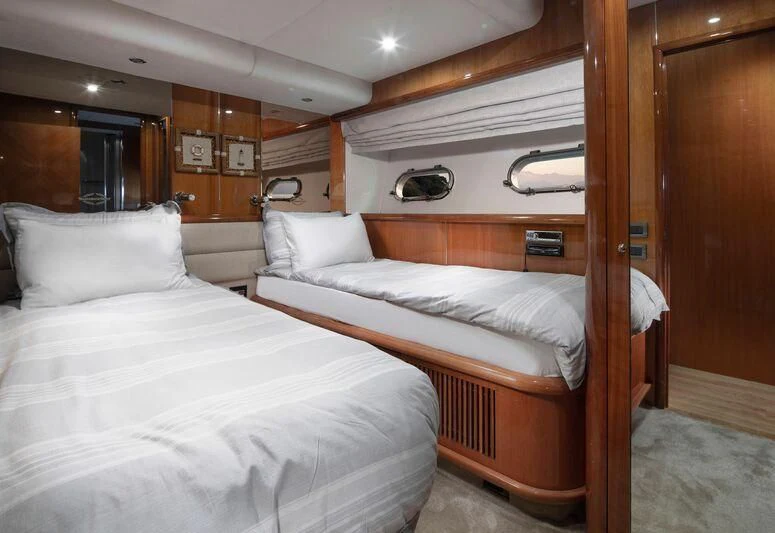 a room with beds and a wood door aboard SPACE ODDITY Yacht for Sale