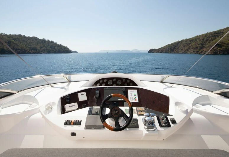a white car with black text on it driving on a body of water aboard SPACE ODDITY Yacht for Sale