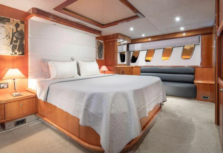 a bed with a white sheet aboard SPACE ODDITY Yacht for Sale