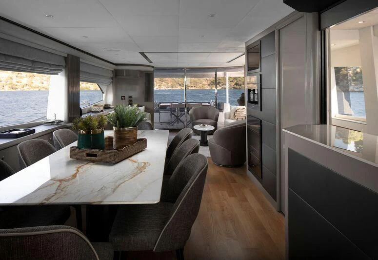 a room with a table and chairs aboard SPACE ODDITY Yacht for Sale
