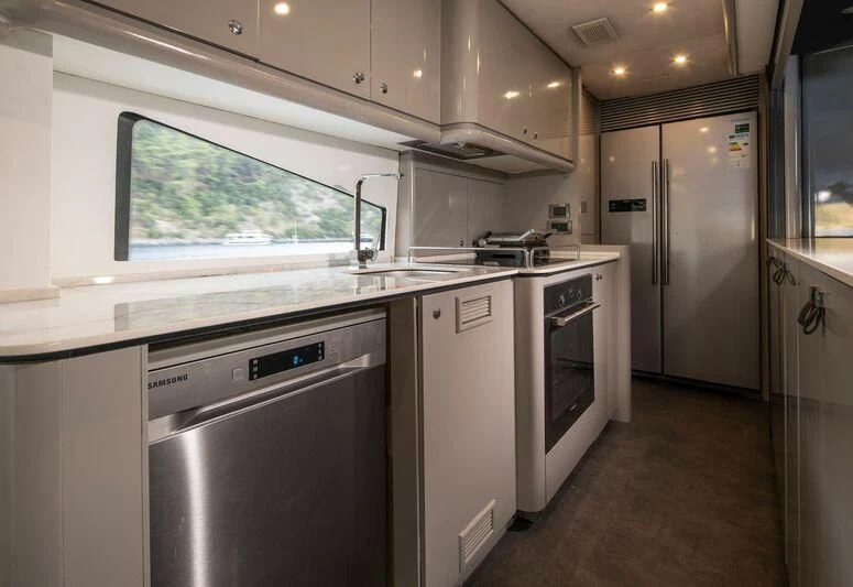 a kitchen with white cabinets aboard SPACE ODDITY Yacht for Sale