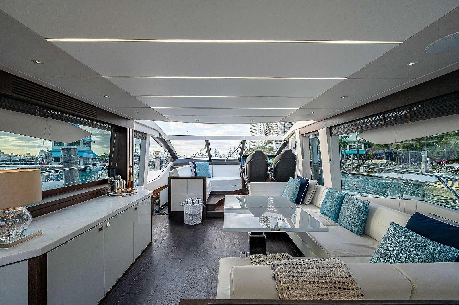 a living room with a large window aboard STRATEGIC DREAMS Yacht for Sale