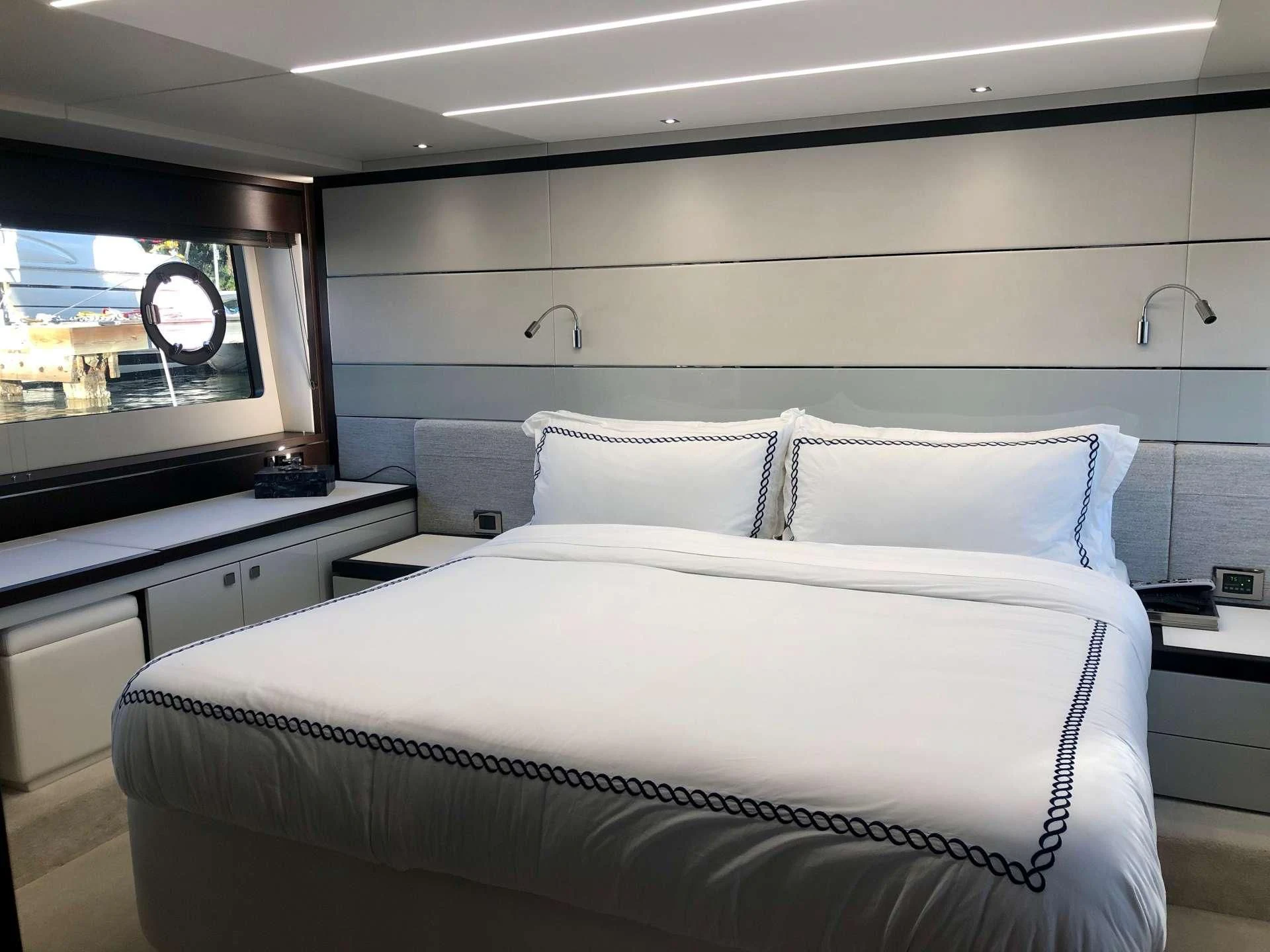 a bed with a white bed spread aboard STRATEGIC DREAMS Yacht for Sale