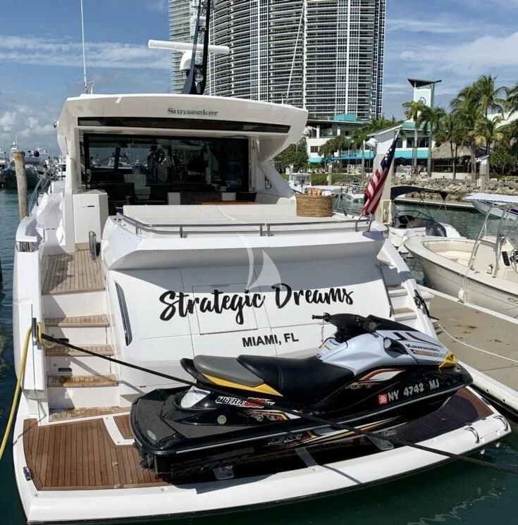 a boat with a flag on the front aboard STRATEGIC DREAMS Yacht for Sale