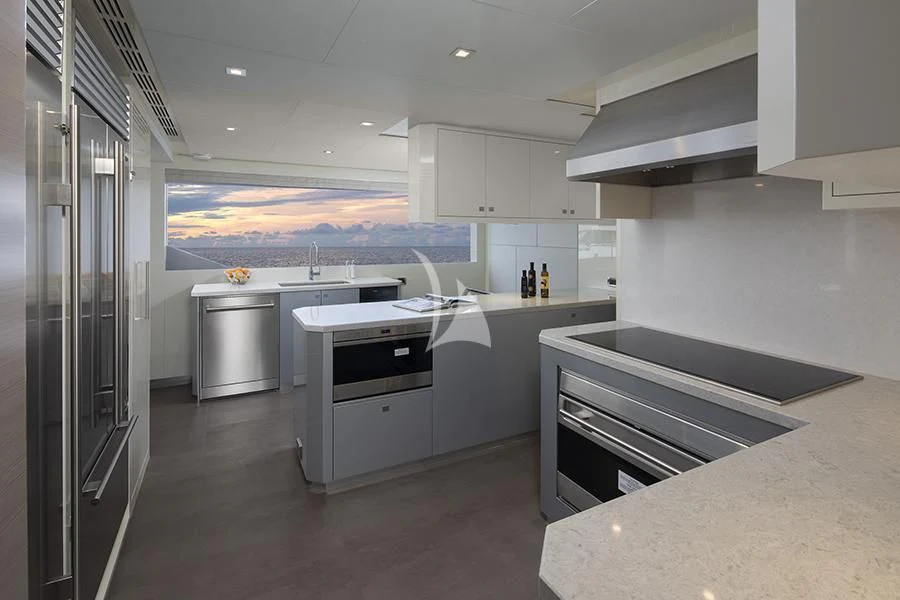 a large kitchen with white cabinets aboard ENTREPRENEUR Yacht for Charter