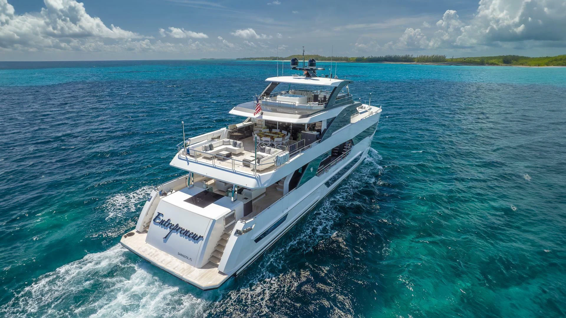 a white boat on the water aboard ENTREPRENEUR Yacht for Charter