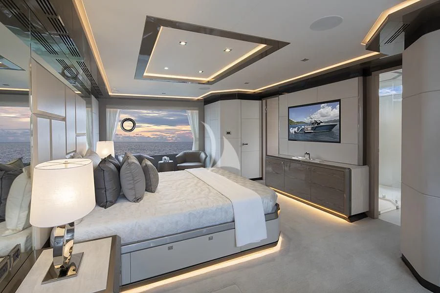 a bedroom with a bed and a desk aboard ENTREPRENEUR Yacht for Charter