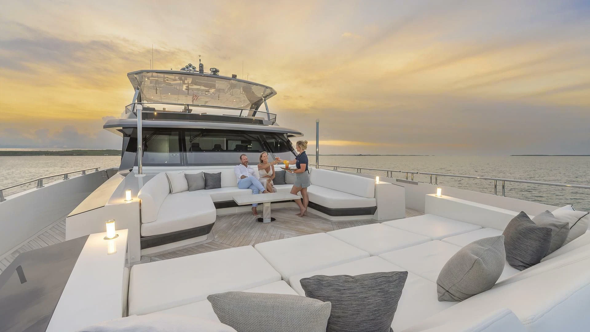 a group of people sitting on a couch on a boat in the water aboard ENTREPRENEUR Yacht for Charter