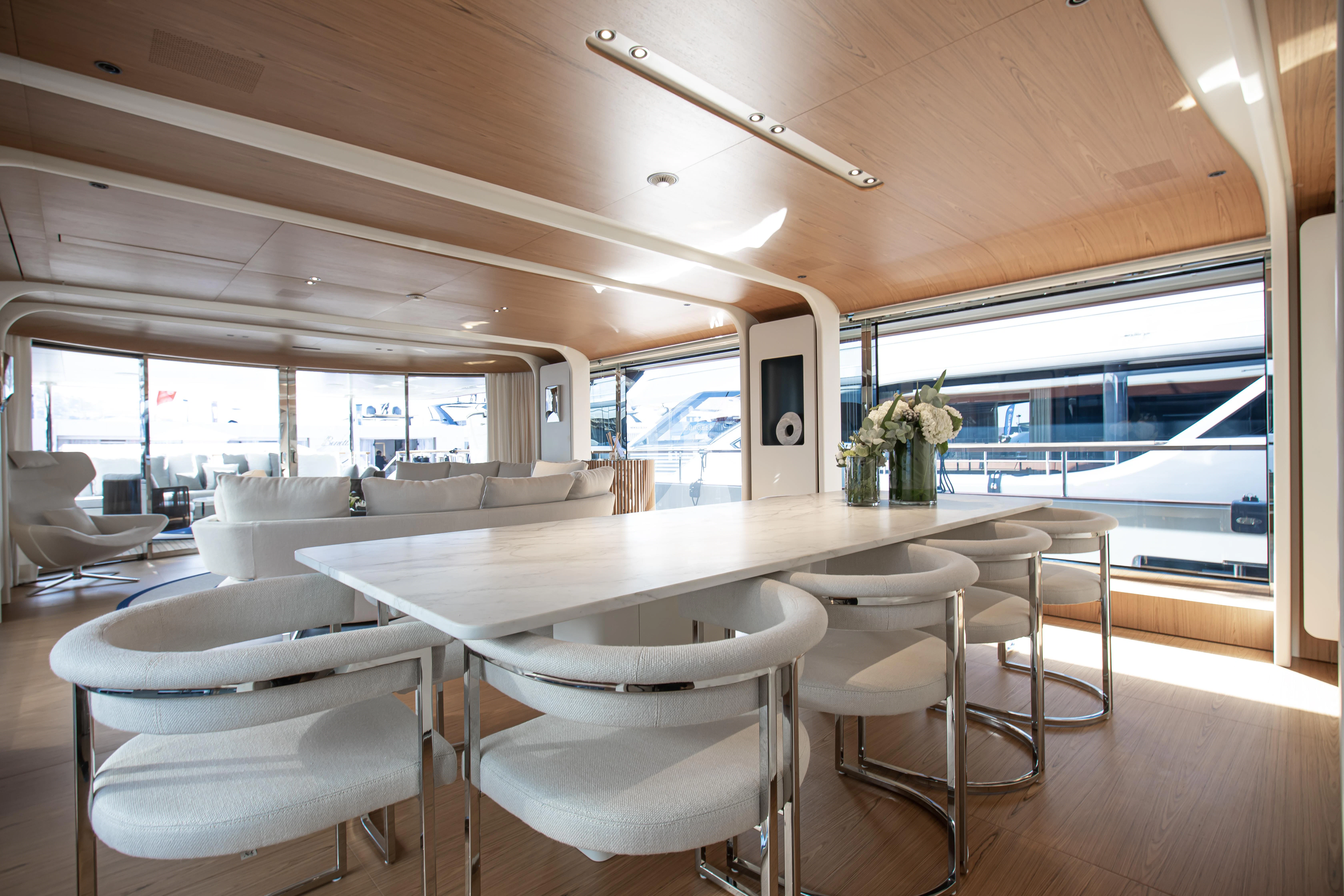 a large room with tables and chairs aboard HAYAT Yacht for Sale