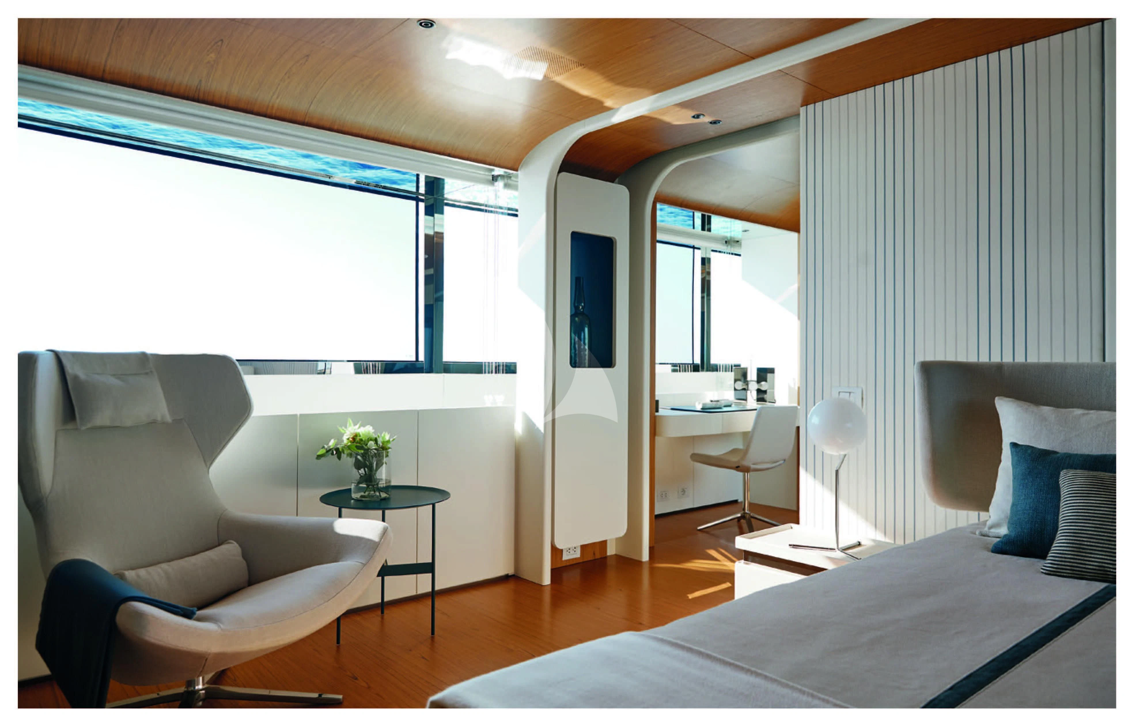 a bedroom with a bed and a desk aboard HAYAT Yacht for Sale