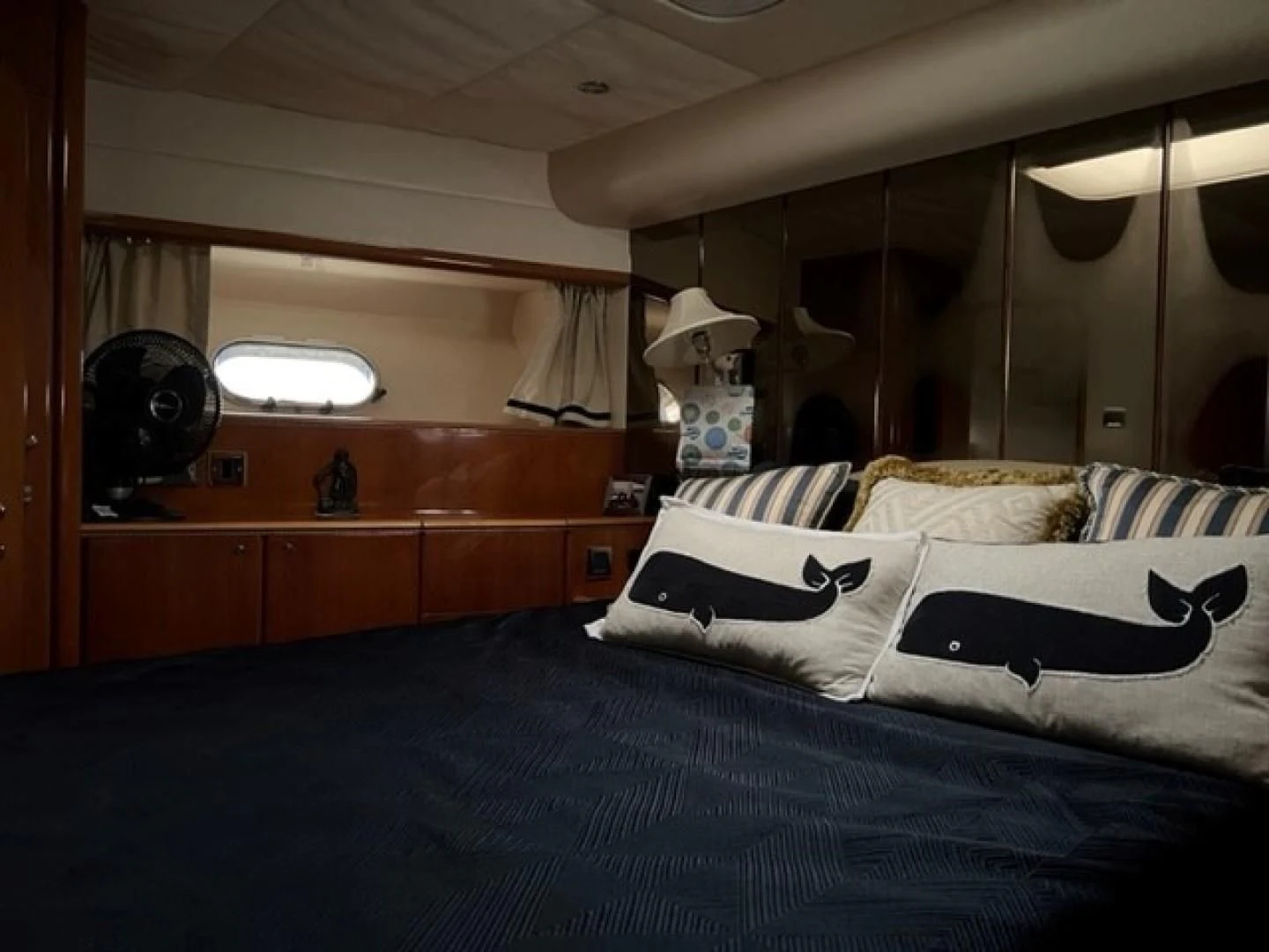 a bedroom with a bed and a mirror aboard JOIE DU ROI Yacht for Sale