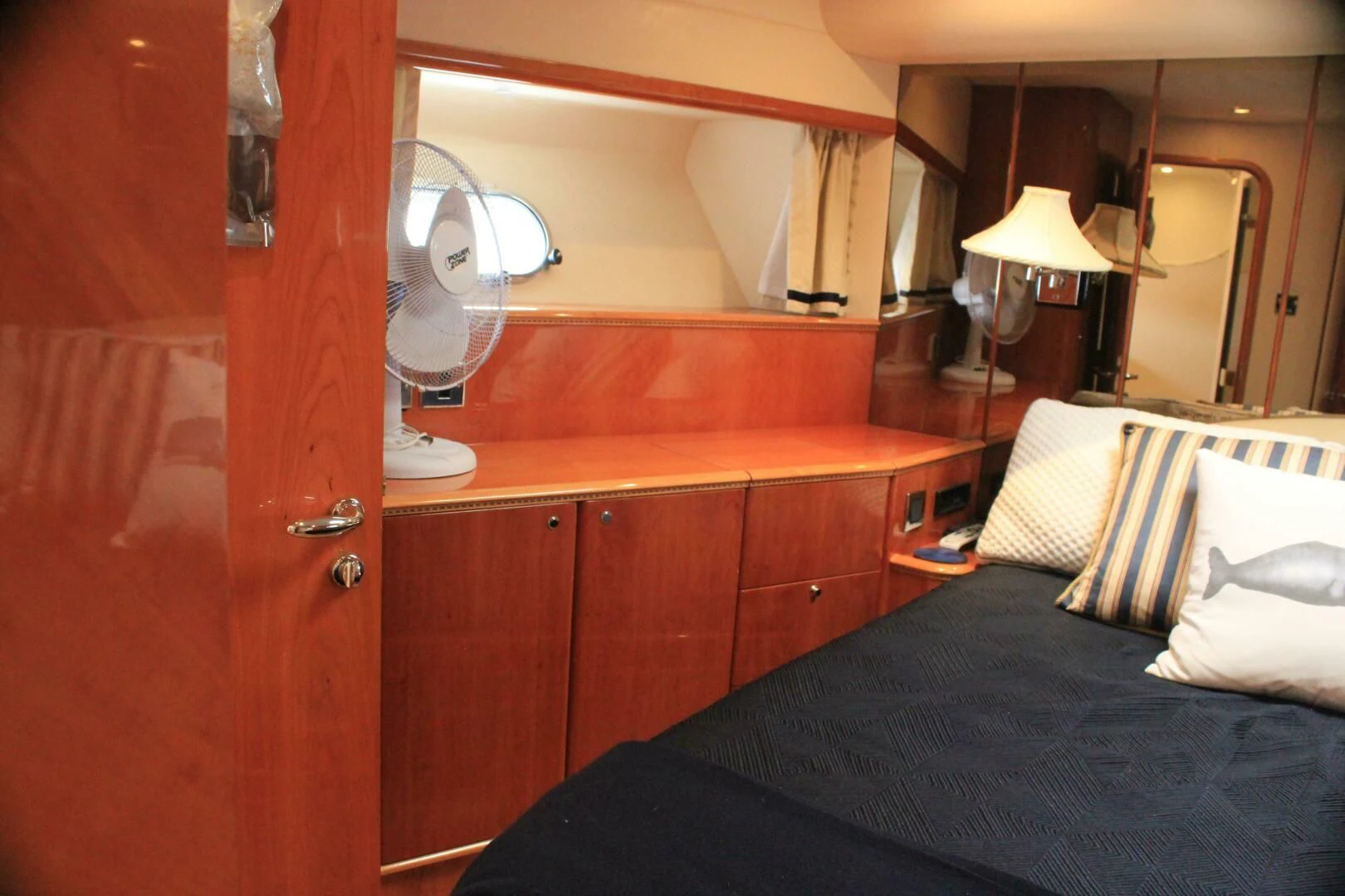 a bedroom with a bed and a dresser aboard JOIE DU ROI Yacht for Sale