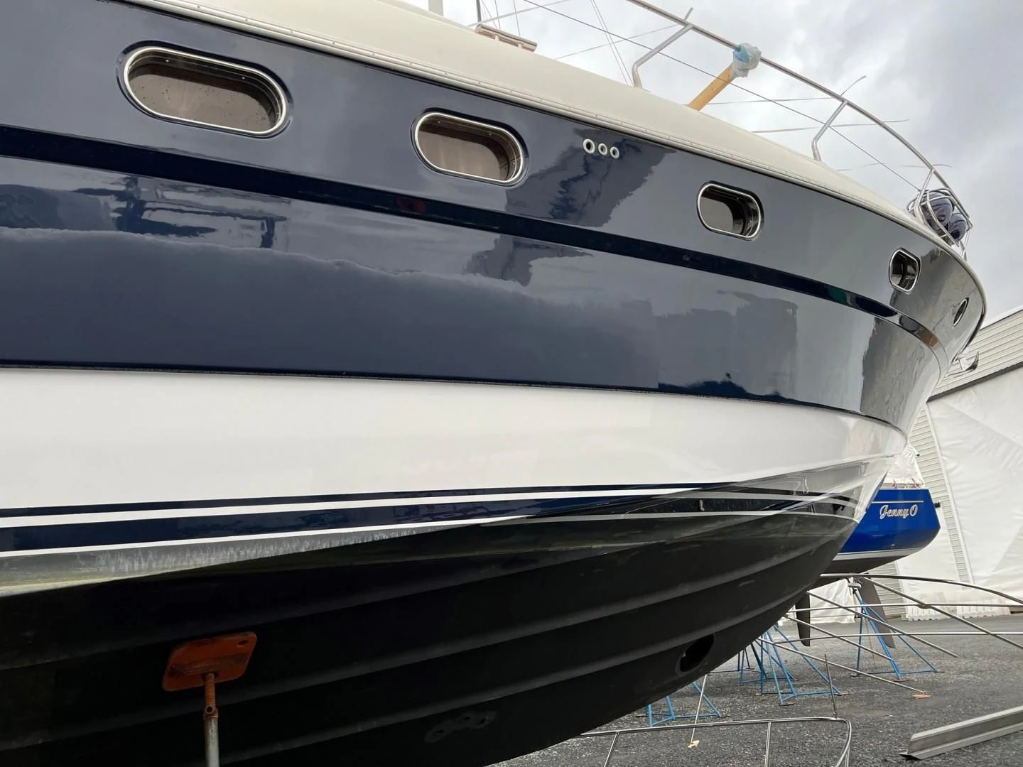 a white yacht with a blue stripe aboard JOIE DU ROI Yacht for Sale