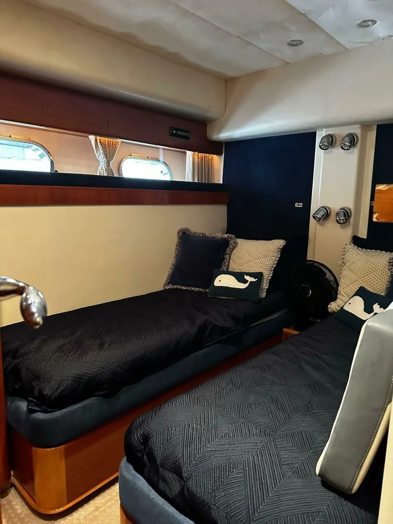 a black couch in a room aboard JOIE DU ROI Yacht for Sale